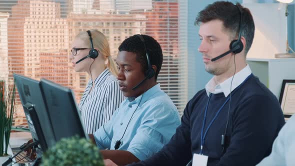 African Customer Service Representative Working on Multiracial Team of Modern Call Center