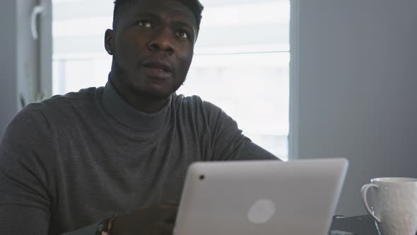 African American Black Man Working on the Laptop in His Appartment