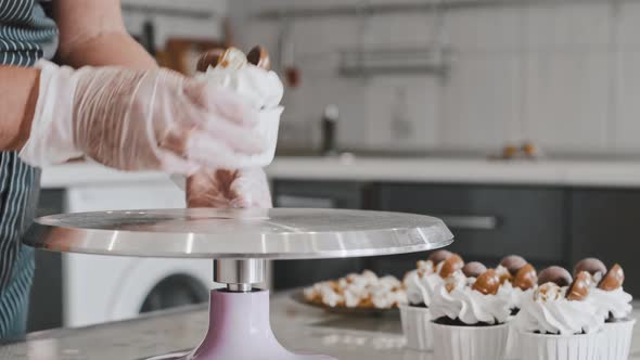 A Chef Putting Decorated Cupcake on the Serving Plate