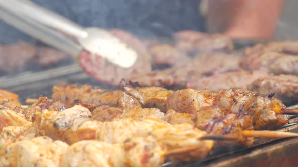 Pieces of Fresh Meat are Grilled on a Grill at a Street Food Festival