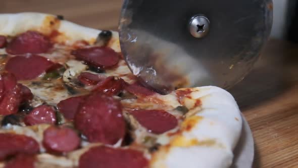 Cutting Pizza with a Round Cutter Knife. Slow Motion 240 Fps