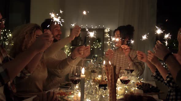 Happy Friends Having Christmas Dinner at Home