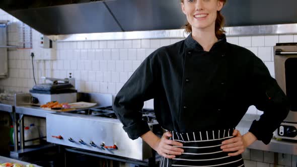 Chef standing with hands on hip in restaurant