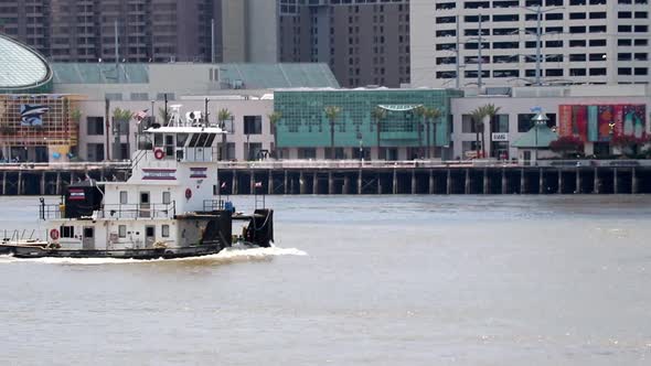 Tugboat traveling along the Mississippi river in New Orleans