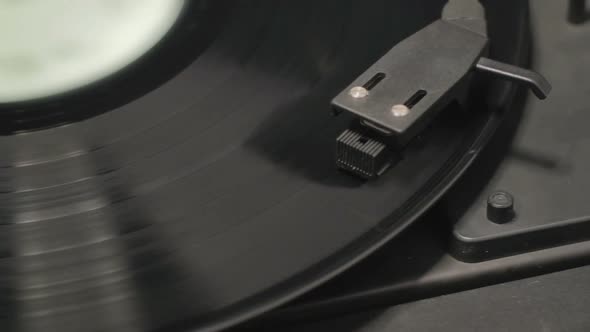 Detail of vintage record player with spinning vinyl. Shallow focus