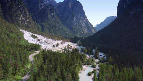 Cars Driving on the Road Stretching Between the Mountains