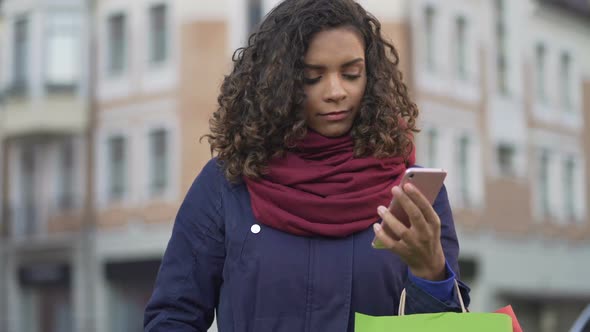 Woman Choosing Gifts Online Browsing Sales in Web Stores on Smartphone