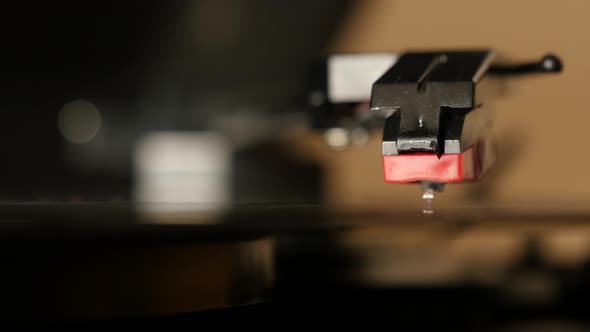 Turntable vinyl record player, man puts a vinyl record and includes a gramophone