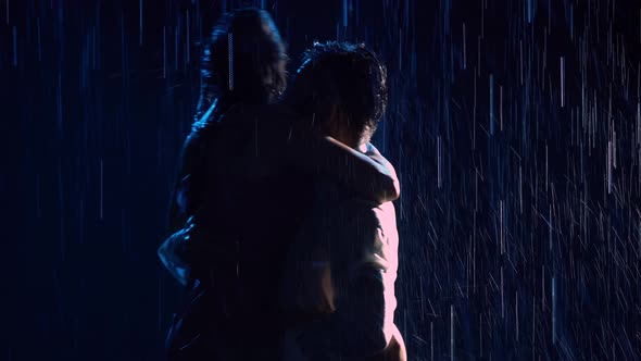 Happy Lovers Perform a Dance of Passion in the Rain and Enjoy Each Other