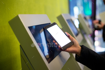 Woman using the ticketing system by cellphone with NFC technology