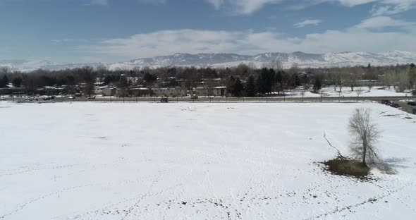 A flight above a snowy field in Fort Collins Colorado March 2021 after historic snow storm.  Rocky m