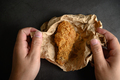 Crispy fried chicken on brown paper and paper handle hand. - PhotoDune Item for Sale