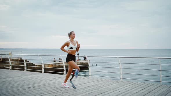 Young Disabled Female Runner Training at Seaside Slow Motion