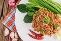 Spicy Minced Pork Salad on a white plate with lentils, kaffir lime leaves and spring onions. - PhotoDune Item for Sale