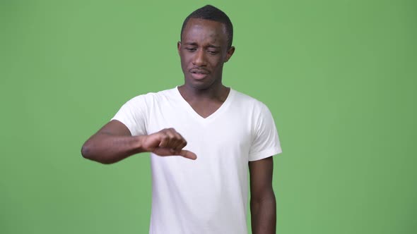 Young Sad African Man Giving Thumbs Down