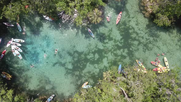 Three sisters spring near Crystal River, Florida. Kayakers and swimmers, aerial top down view