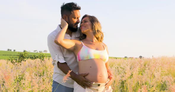 First-time parents exchanging caresses in the midst of nature, waiting for a new life that will tota