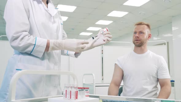 Doctor is Injecting a Patient with Coronavirus Vaccine