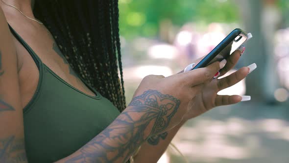 media, globalization - young south american woman types quickly on phone