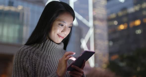 Woman use of mobile phone at night