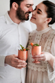 Smiling couple celebrating holiday with ice cocktail in goblets - PhotoDune Item for Sale