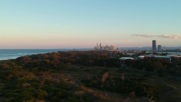 Aerial view of a large area of green space with a sprawling city in the distant