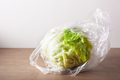 iceberg lettuce salad vegetable in plastic bag. single use plastic packaging issue - PhotoDune Item for Sale