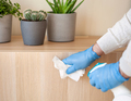 man hands in gloves disinfecting chest of drawers handle, killing virus on surface - PhotoDune Item for Sale