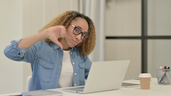 Thumbs Down By African Woman at Work