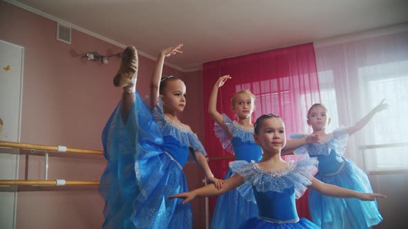 Four Little Girls in Blue Dresses Training Their Dance Before the Performance