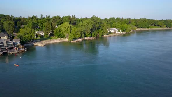 Aerial view of attractive waterfront homes in a scenic small town.