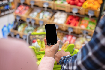 Cropped view of black couple holding cellphone with blank screen at mall, mockup for mobile / Photodune, Misc