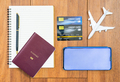 Airplane by passport and cellphone with notepad - PhotoDune Item for Sale