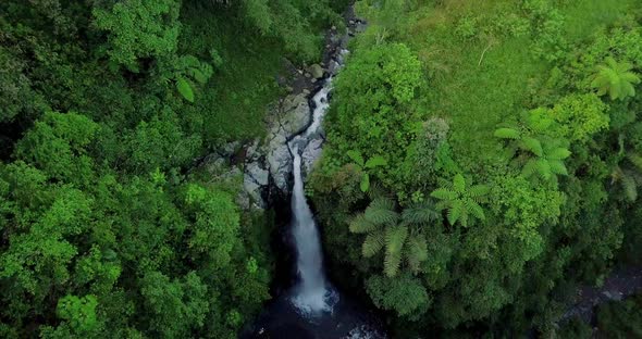 Aerial view from drone flying over nature view of waterfall with surrounding vegetation. nature is s