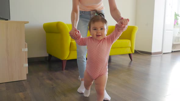 Cute Smiling Nice Baby Girl Learning to Walk in the Living Room