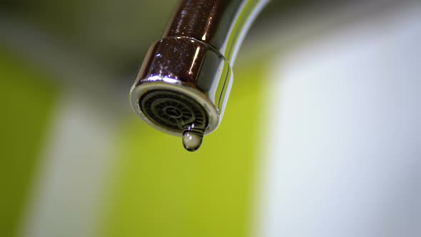 Water Dripping From the Tap Into a Sink