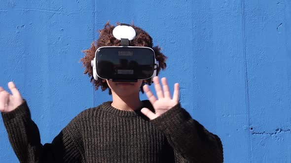 Ethnic teenager in VR headset exploring cyberspace