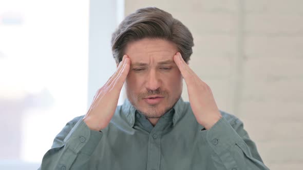 Portrait of Middle Aged Man having Headache