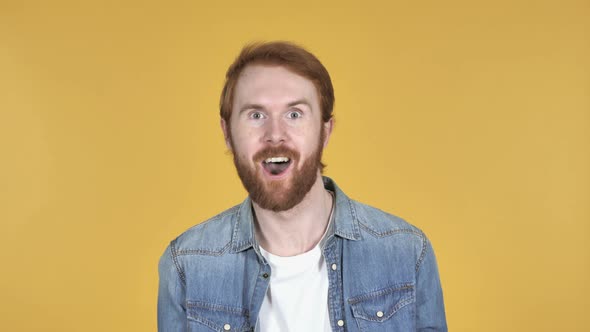 Crazy Redhead Man Doing Funny Movements, Yellow Background