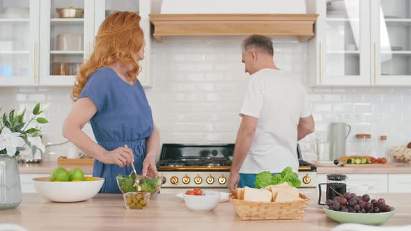 Aged Man and Woman Cooking Together