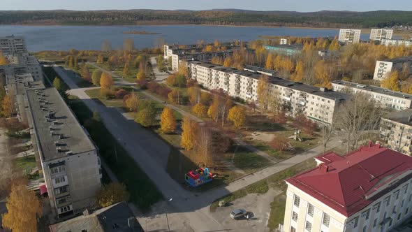 Aerial view of house of culture, alley and pond in a provincial autumn town 25