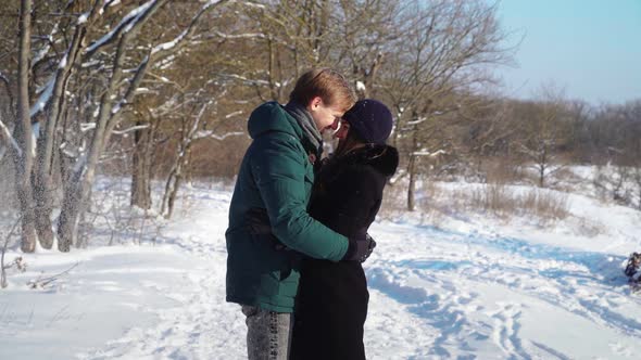 Happy Couple Having Fun in Winter Forest