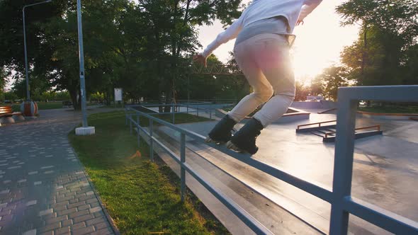 Aggressive Inline Roller Skater Doing Tricks in Concrete Skatepark Outdoors Slow Motion Tracking