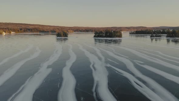 Sunset over frozen Moosehead Lake. Maine. USA. Aerial forward