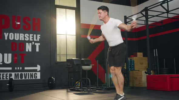 4K Caucasian man do sport training skipping jump rope exercise at gym.