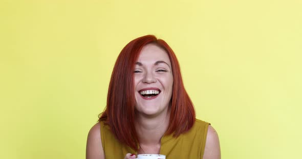 Happy Red-haired Woman with a Cup Coffe or Tea.