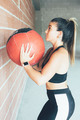 Concentrated_fit_woman_doing_wall_ball_routine - PhotoDune Item for Sale