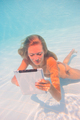 Young woman undewater with tablet computer - PhotoDune Item for Sale