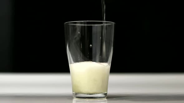 Close Up Background of Pouring Beer with Bubbles and Foam in Glass Low Angle View