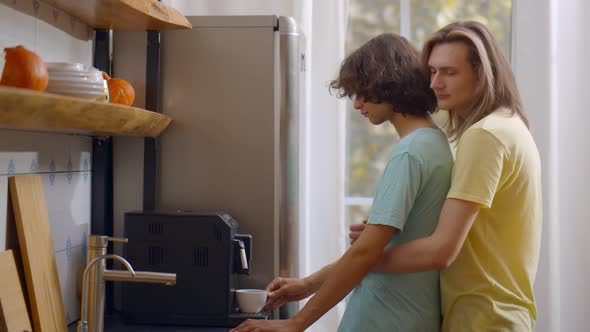 Young Gay Couple at Home in Kitchen Making Fresh Coffee